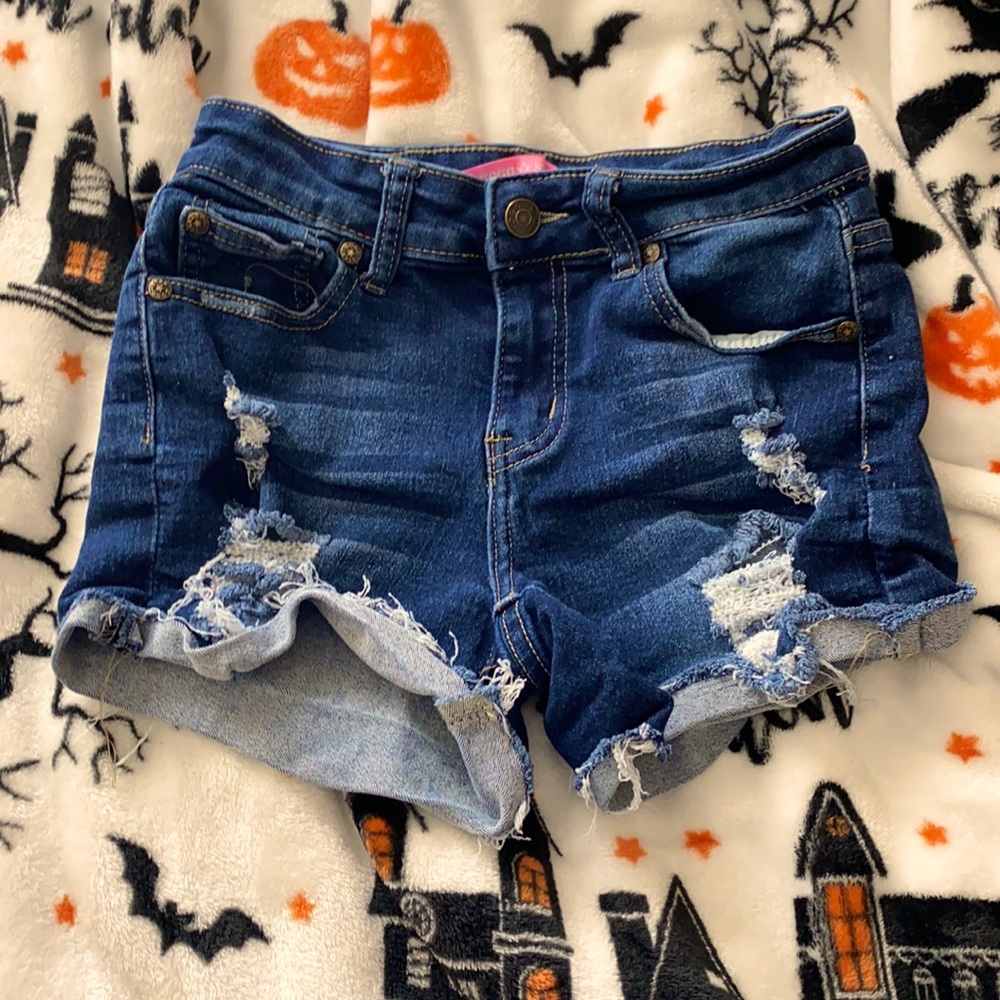 This is a pair of ripped jean shorts. They are a size 12 girls.